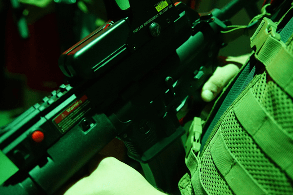 Player holding laser tagger tactical sight